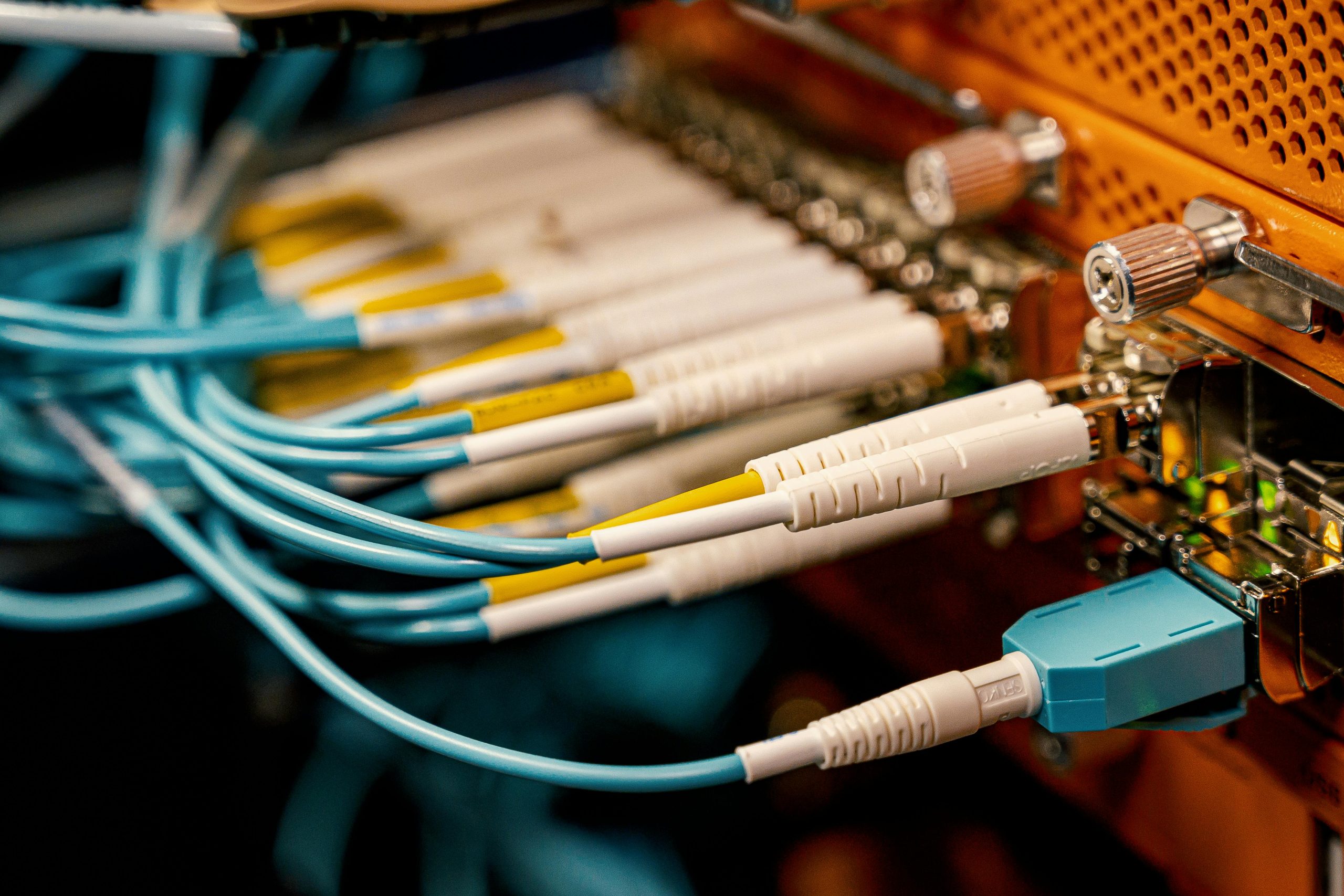 Fiber optic cables connected to network switch in data center