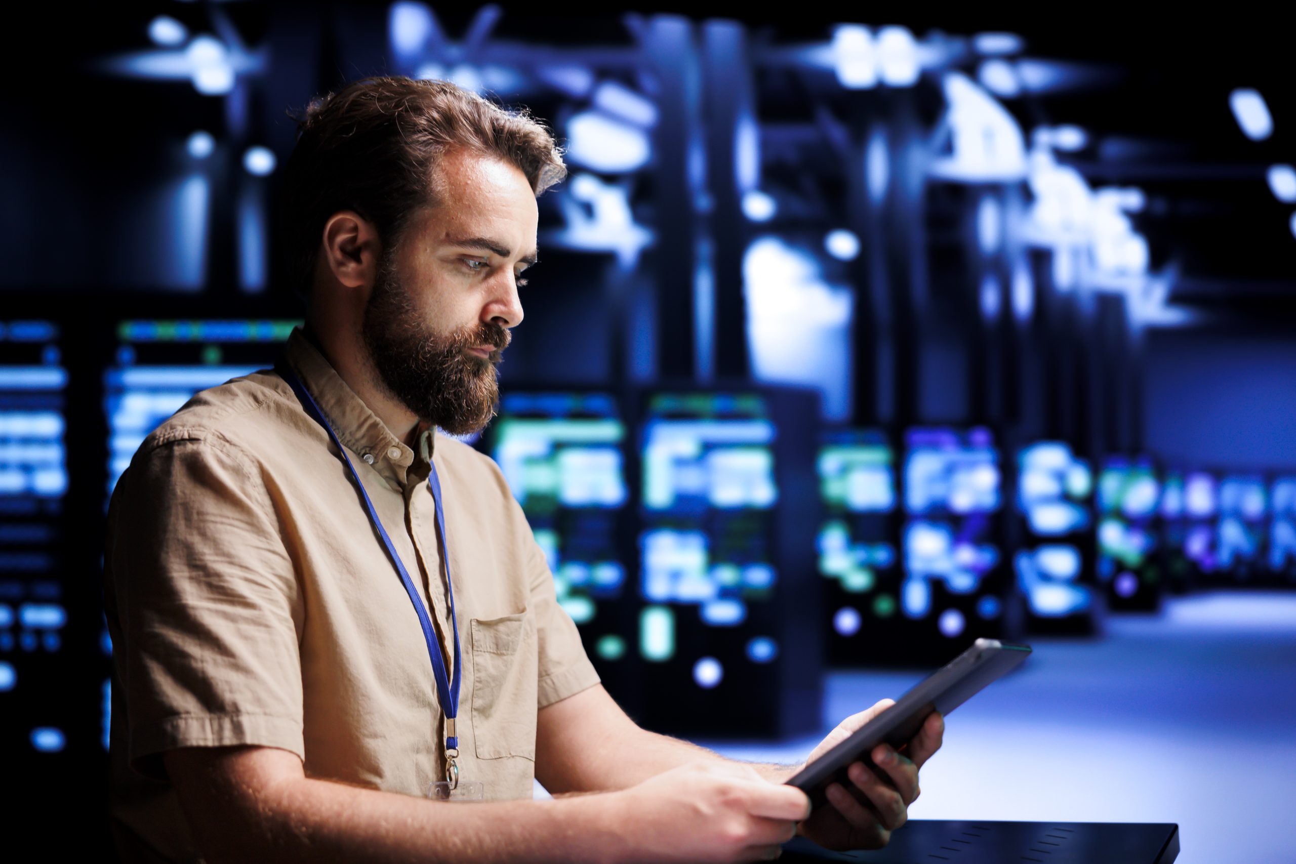 Network technician monitoring systems in data center